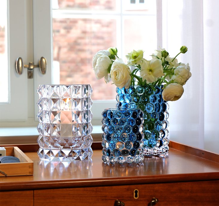 Two Skogsberg&Smart glass vases with diamond and bubble textures in blue tones on a wooden windowsill