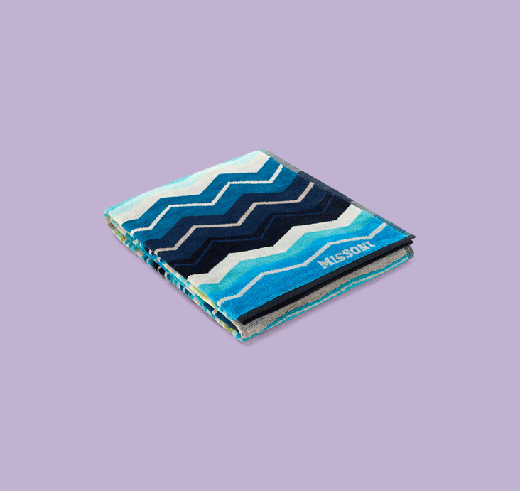 Three Missoni home accessories featuring the brand's iconic multicolour zigzag pattern on a lilac background