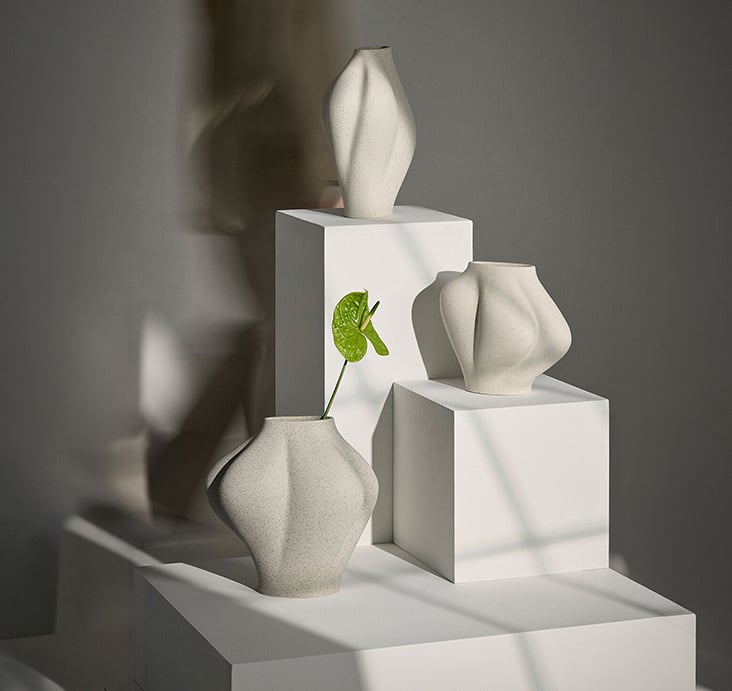 A sculptural white AYTM 'Saltare' vase with faceted geometric forms